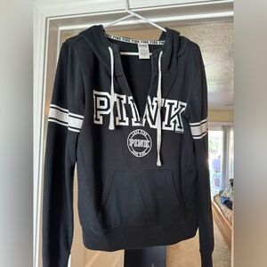 PINK half zip-up hoodie in black with white logo on the front